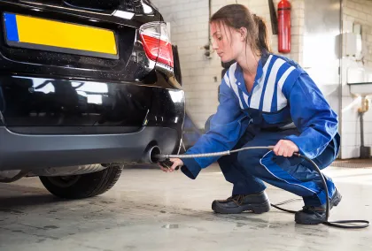 Picture of a mechanic working in a exhaust