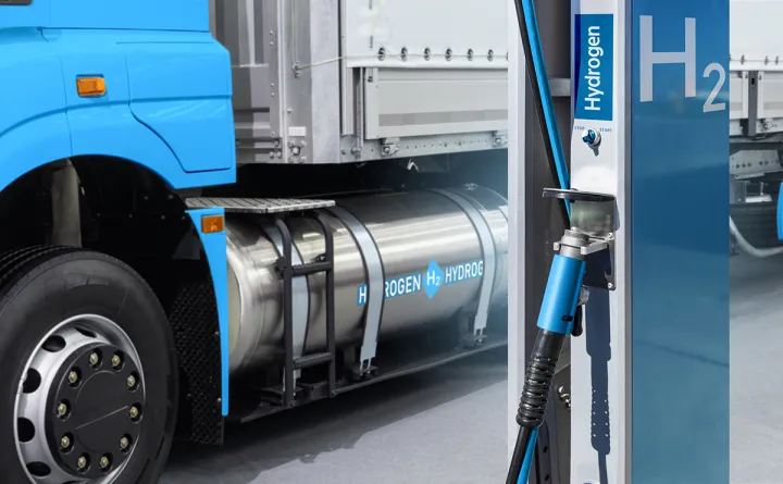 Close-up shot of a hydrogen-powered truck at a fuel pump.