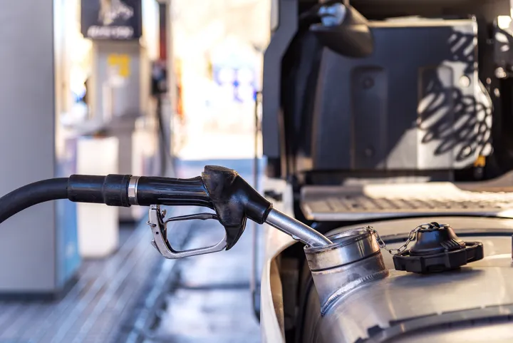Close-up shot of a truck being fueled up at a gas station.