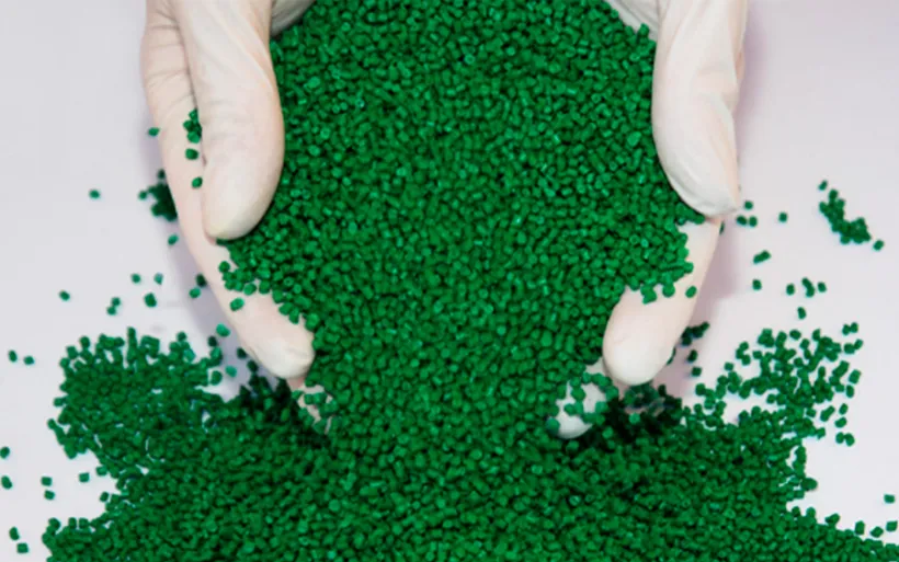Human hands manipulating green plastic